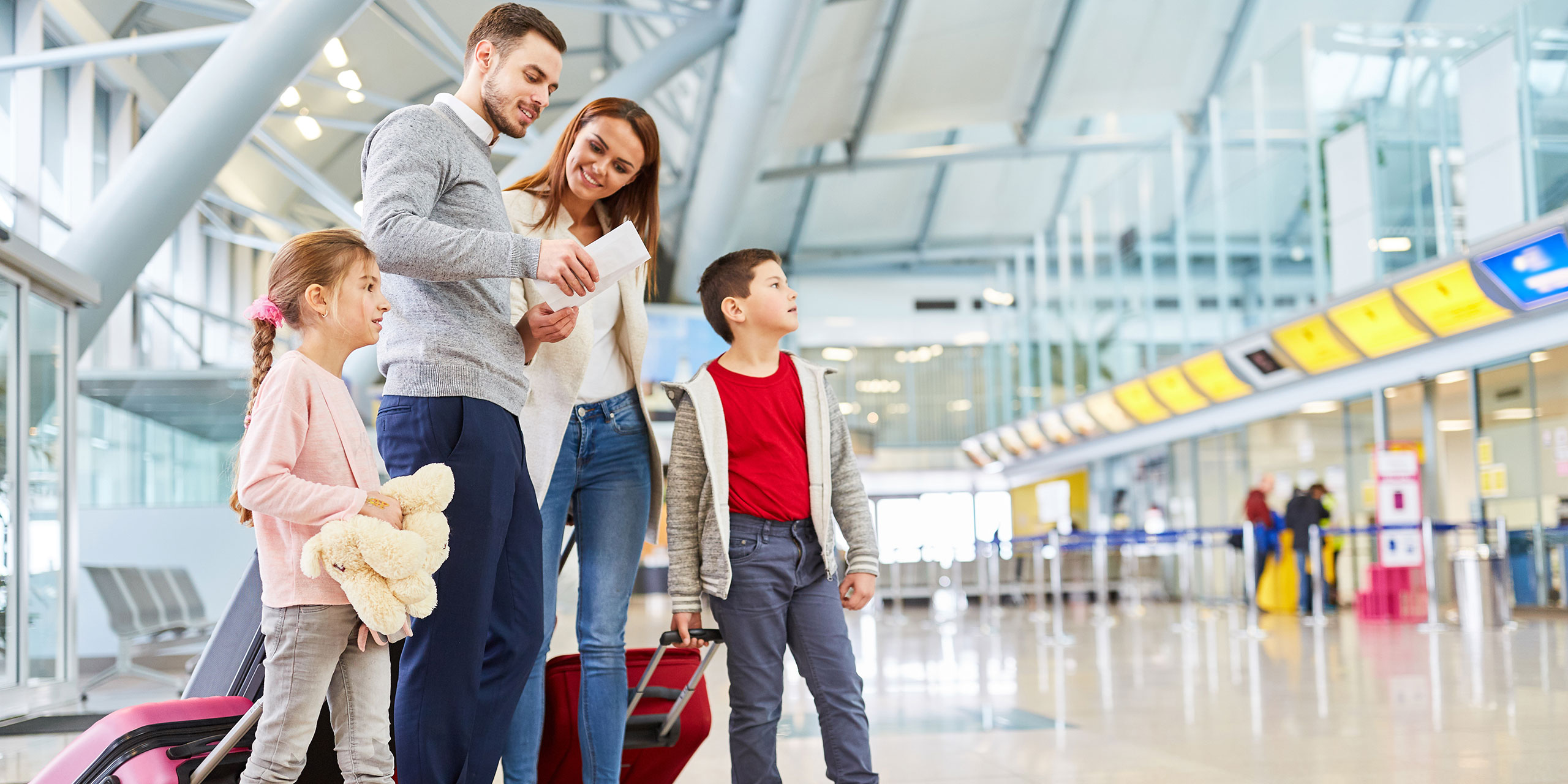 Family Standing in Airport; Courtesy of Robert Kneschke/Shutterstock.com